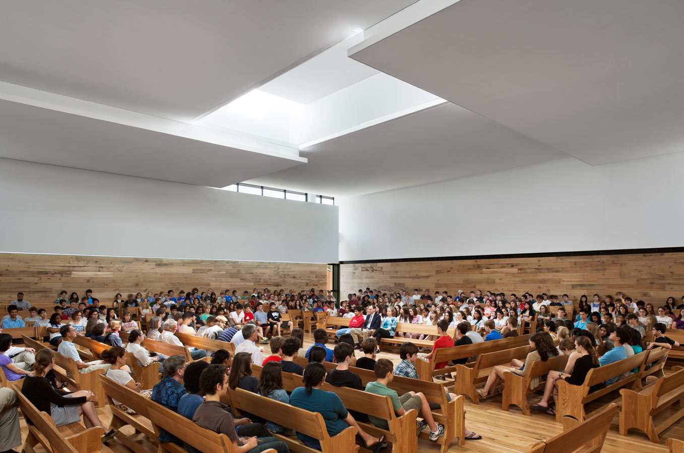 <p>The Meeting House is designed to filter light, views, and sounds from the surge of activity around the center of the campus. Panels on the ceiling are arranged in a pinwheel pattern around a central skylight, a void of light around which form and order are created. <br><small>&copy; Michael Moran/OTTO</small></p>