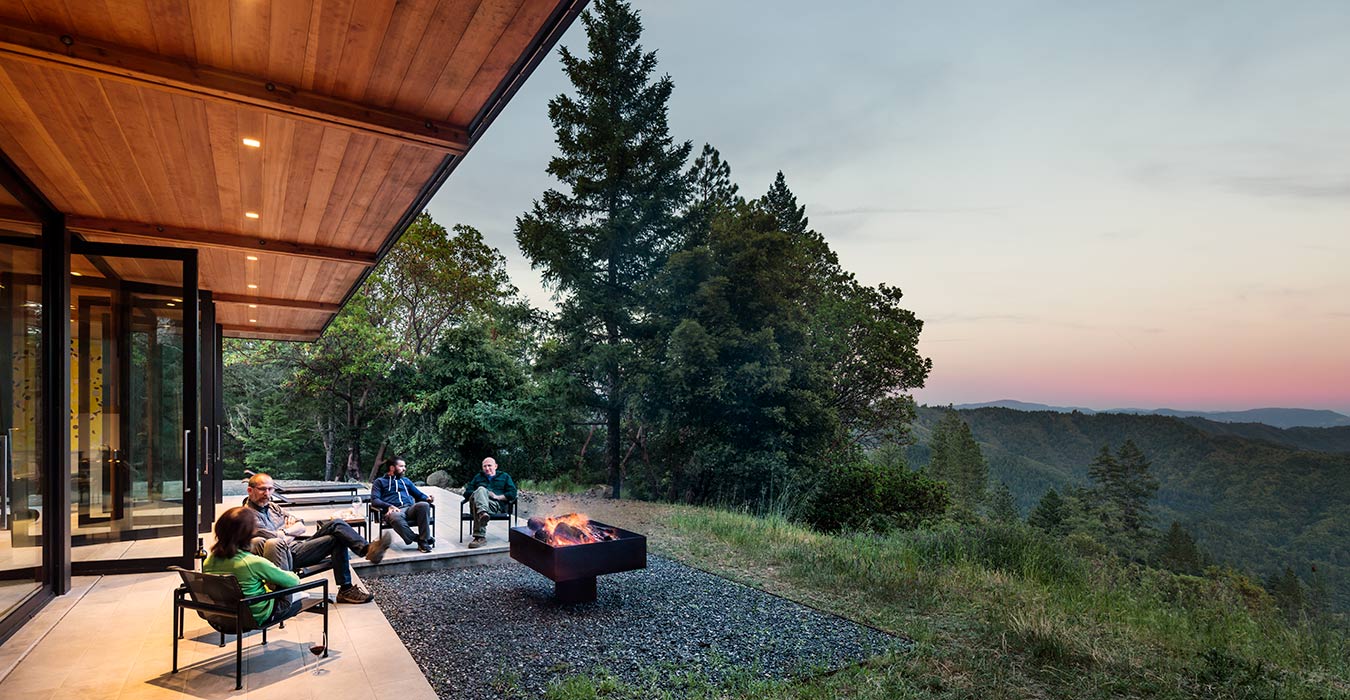 <p>A patio and fire pit create an outdoor room overlooking the valley below. <br><small>&copy;Tim Griffith</small></p>