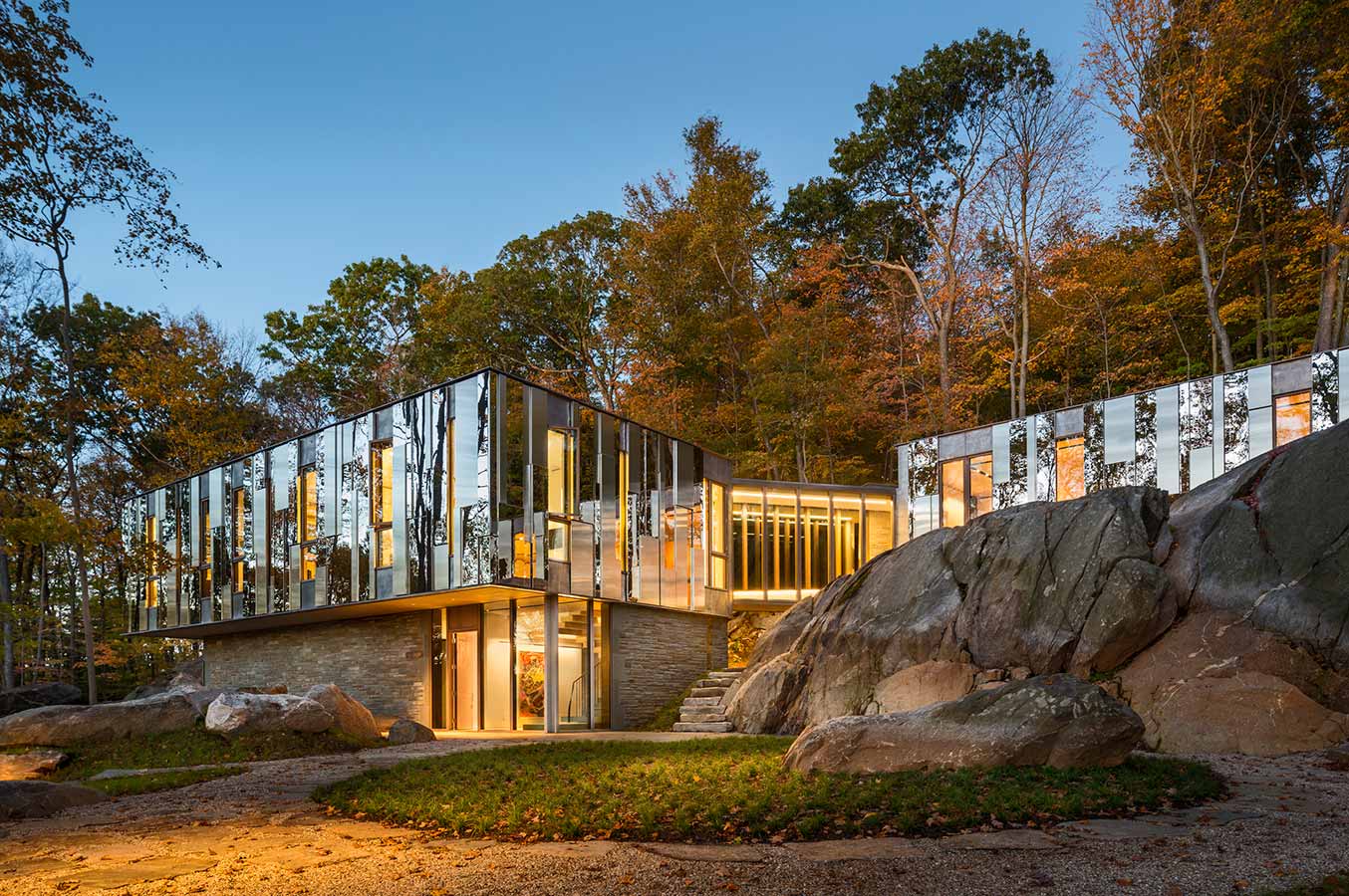 <p>At Pound Ridge House, most of the windows extend from floor to ceiling, parting the wall to reveal framed views to moments in the geology. The metal rain screen wall panels, in turn, reveal their own abstractions of the landscape. <br><small>&copy; Peter Aaron/OTTO</small></p>