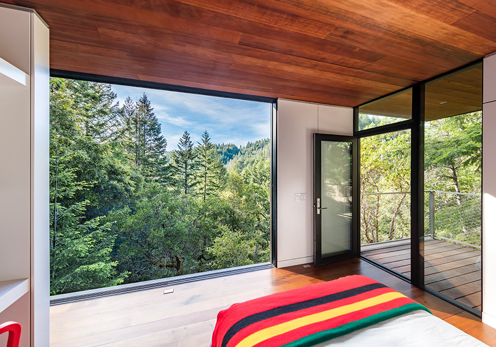 <p>Guest cabins open completely to the outdoors and share the main house's material palette of reclaimed wood, cor-ten steel, and floor-to-ceiling glass. <br><small>&copy;Tim Griffith</small></p>