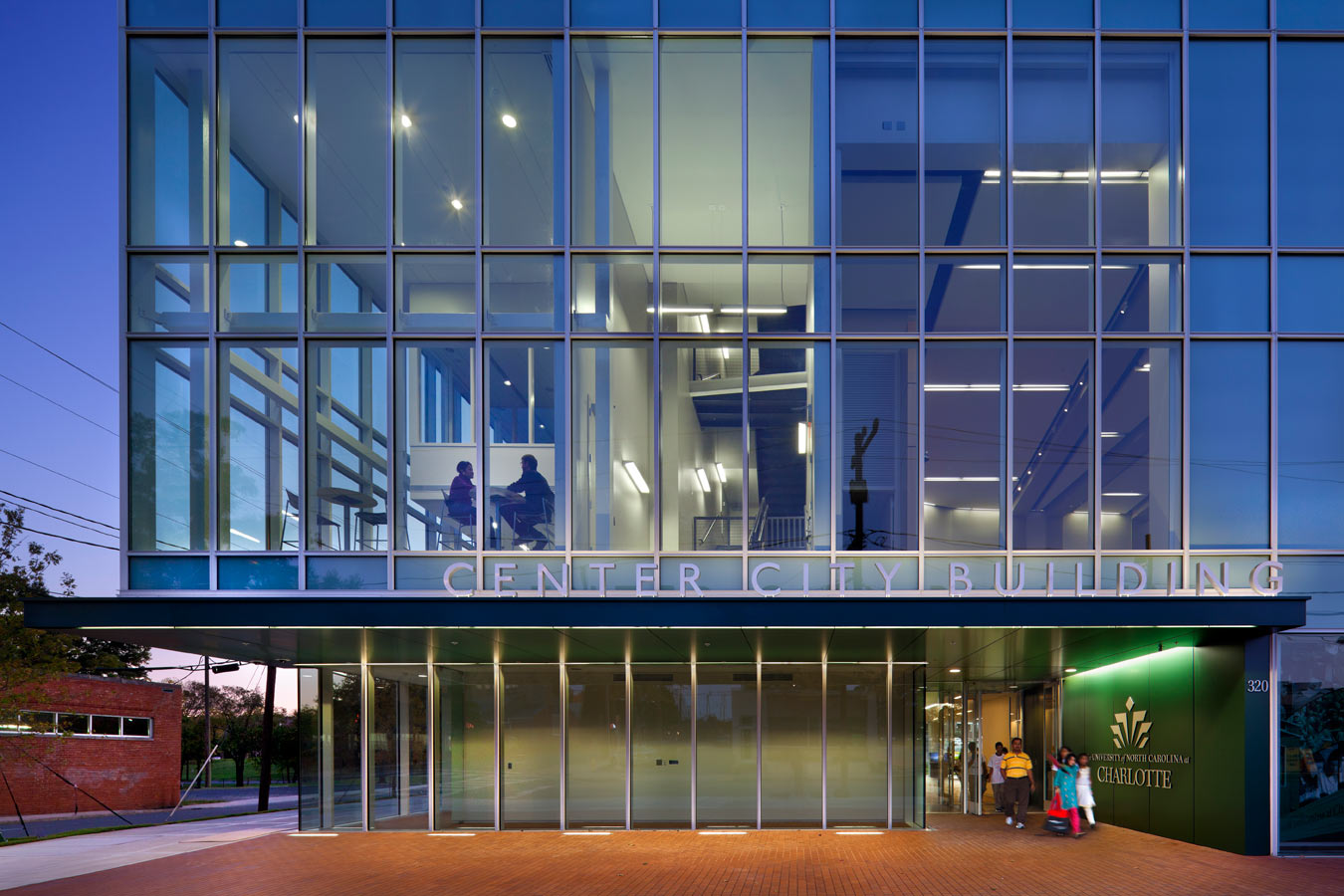 <p>The building's transparency engages its urban context, which is removed from the main campus by about ten miles. Its glass facade reveals a student lounge on the left and the auditorium on the right above the entry. <br><small>&copy; Peter Aaron/OTTO</small></p>