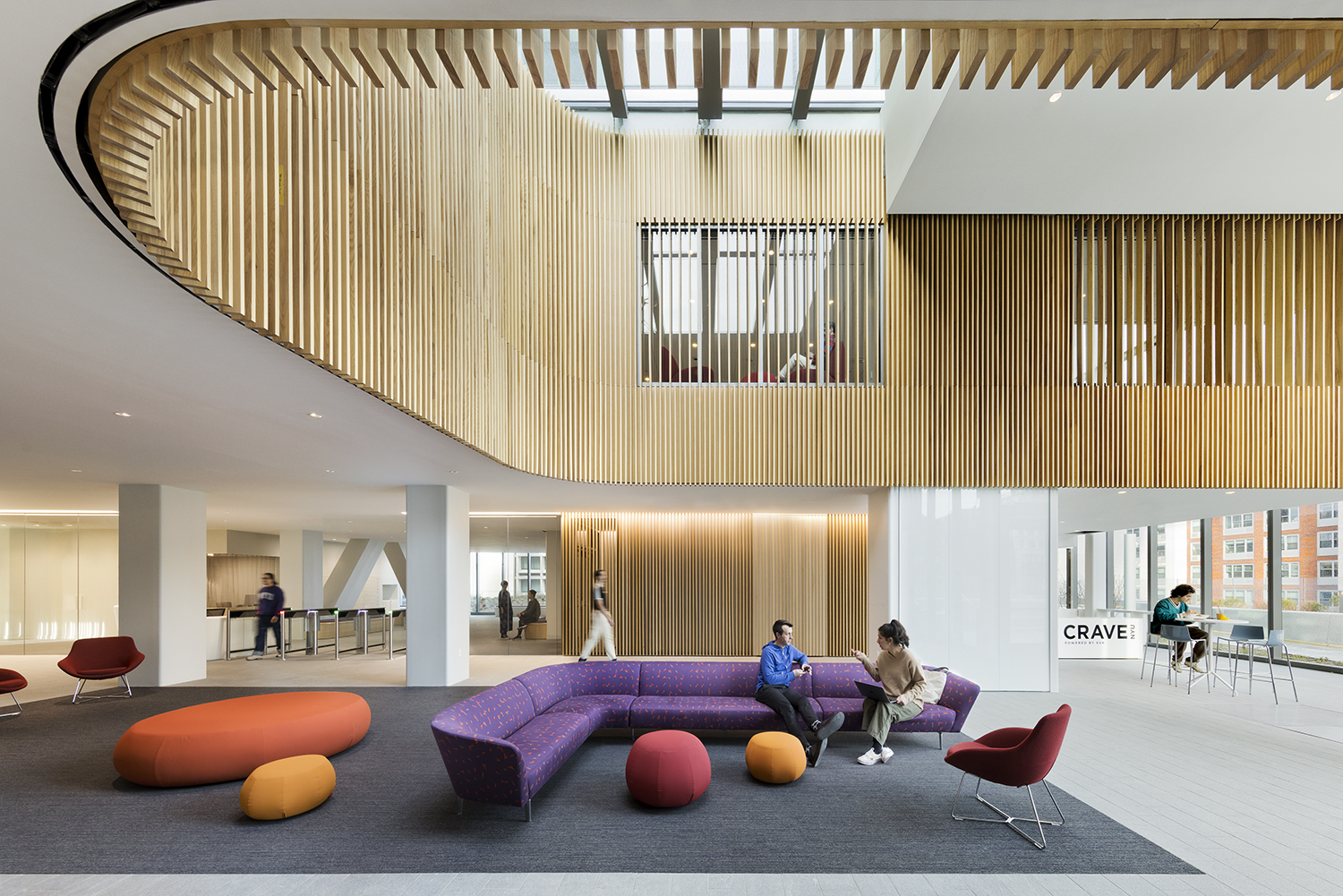 <p>The skylit 6th floor lobby serves as a student social space, providing access to residential living and a café. <small>&copy; Connie Zhou / JBSA </small></p>