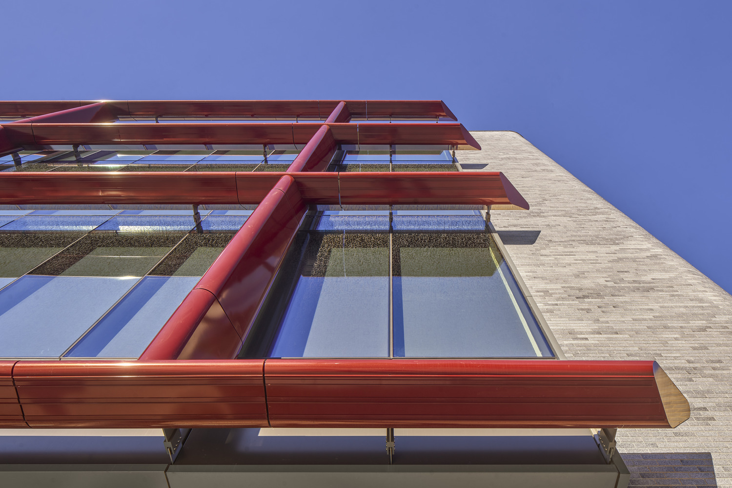 <p>The new east facade with its outboard aluminum frame finished in a glossy red powder coating, custom formulated for this installation, projects a dynamic new image for the building in conversation with the original design.<small> | &copy; Halkin Mason Photography</small></p>