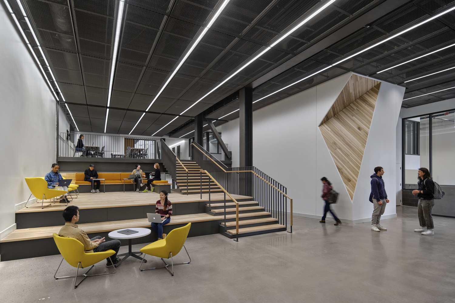 <p>The ground floor co-working lobby can be adapted for lectures, receptions, and informal gatherings alike. Thoughtfully placed wood accents make use of exclusively regionally native tree species, hearkening back to the University's land grant mission. <small>&copy; Halkin Mason Photography</small></p>